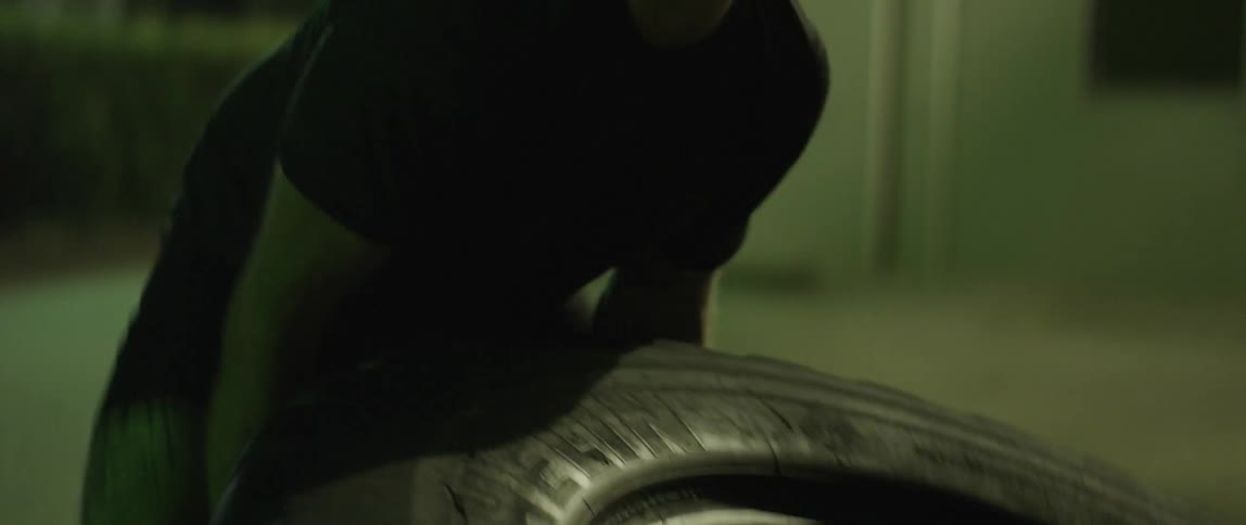 A man flips a tire during a workout