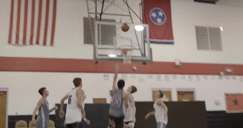 A group of men playing basketball in a gym
