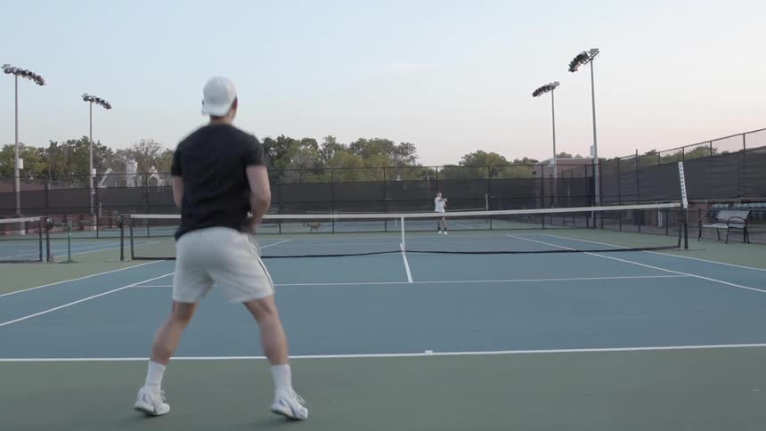 Two people playing tennis