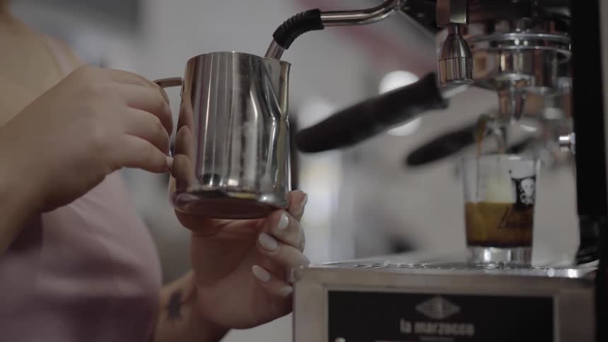 A woman makes a coffee