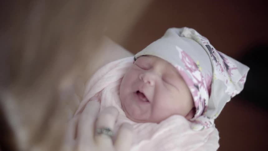 A woman holds a new born baby