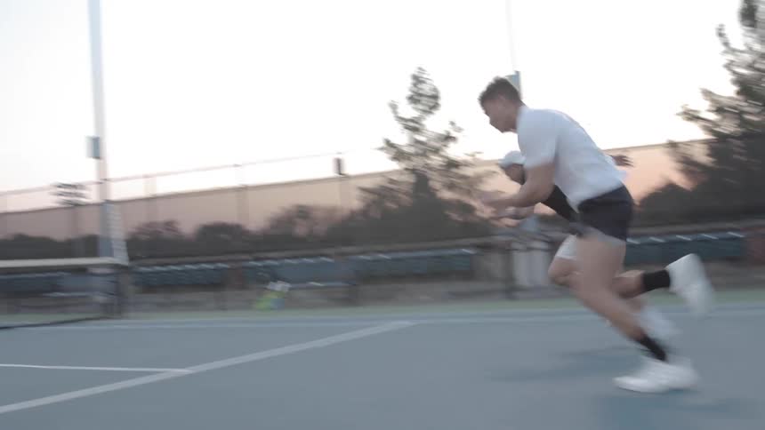 Men do court drill on tennis court