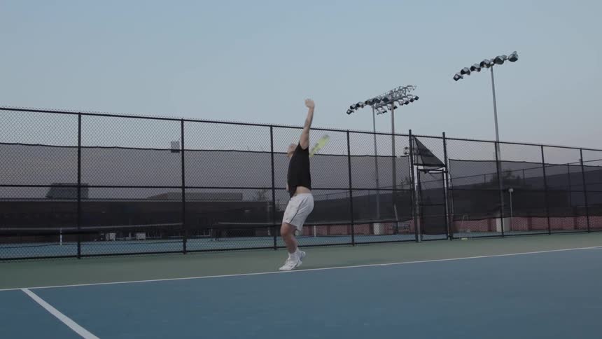Tennis player serving the ball on a tennis court