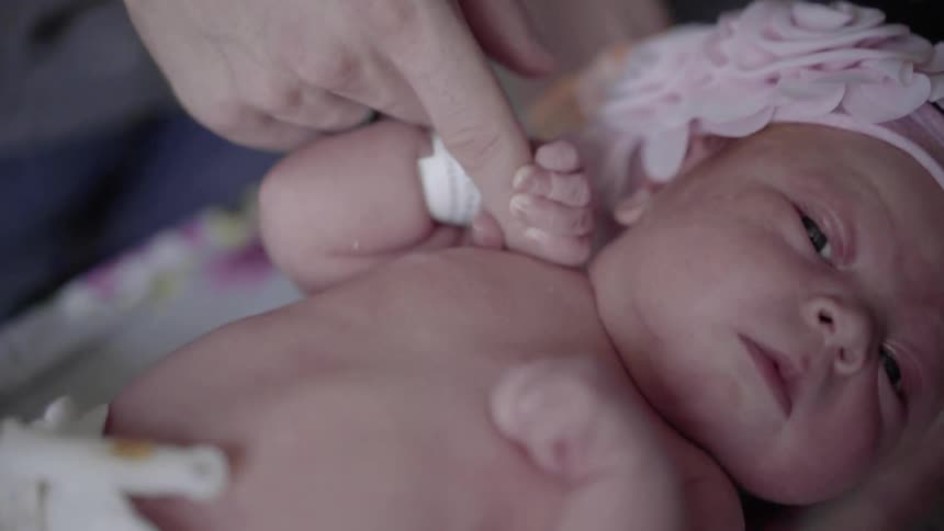 A person giving a finger to a baby