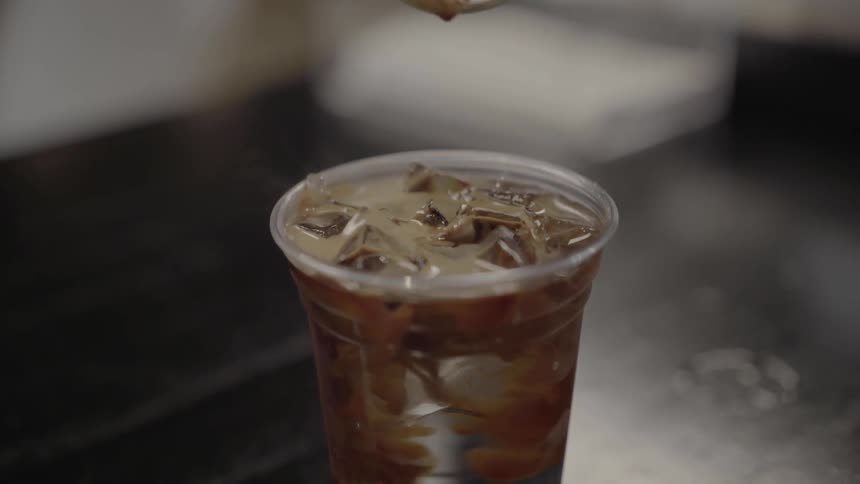 A person pouring coffee into a cup