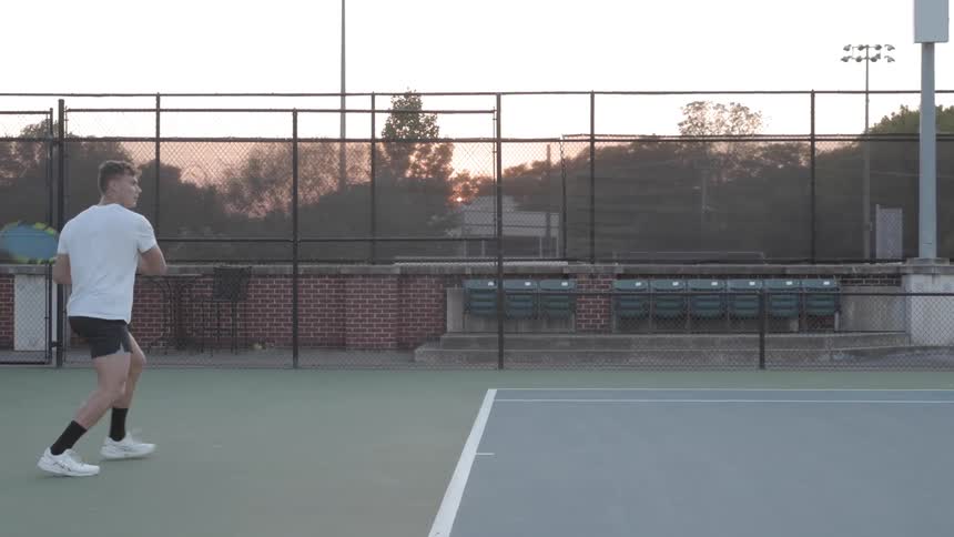 A man playing tennis outdoors