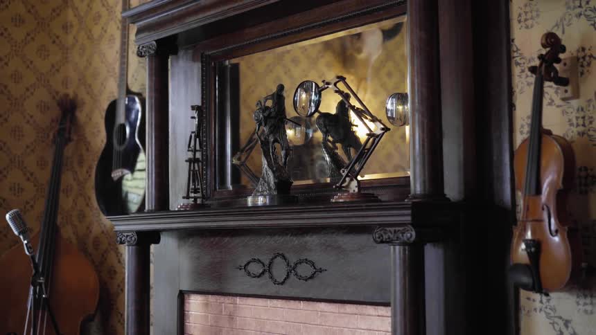 A fireplace is surrounded by musical instruments such as a guitar double bass and violin