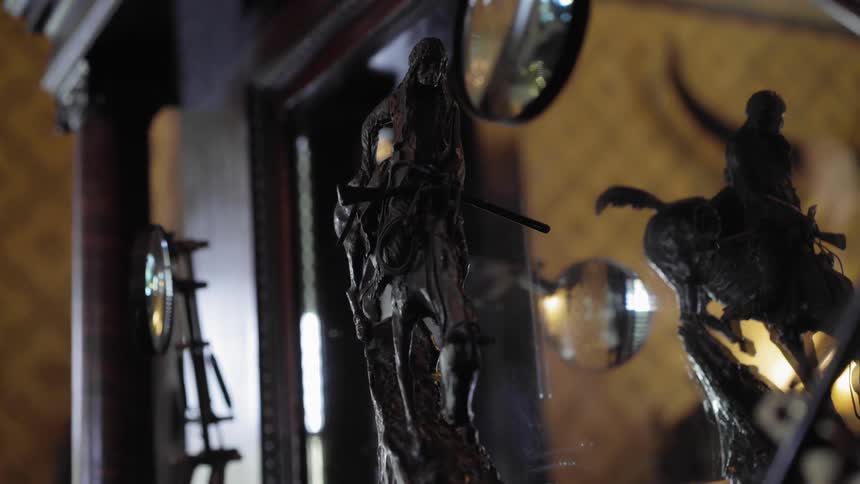 A small statue sits on the side of the cabinet