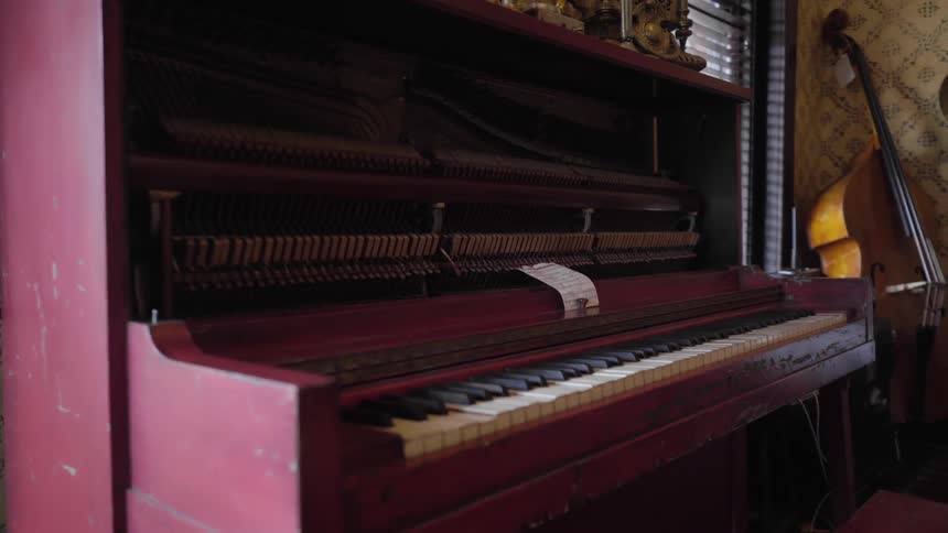 A red piano in a house