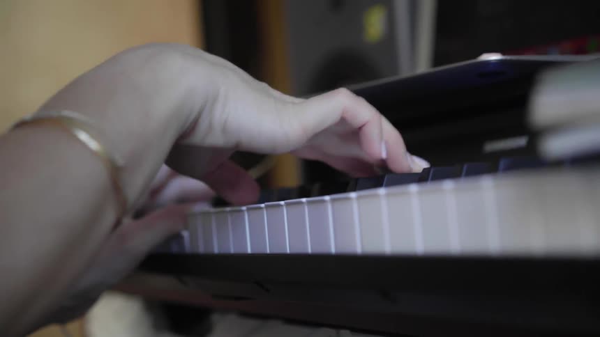 A white woman plays the piano