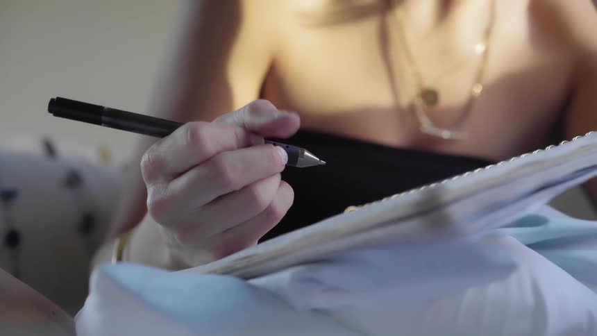 White teenage girl writing in her diary