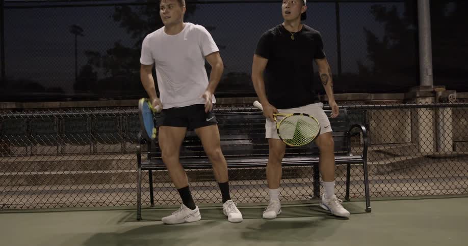 Two tennis players get ready to play