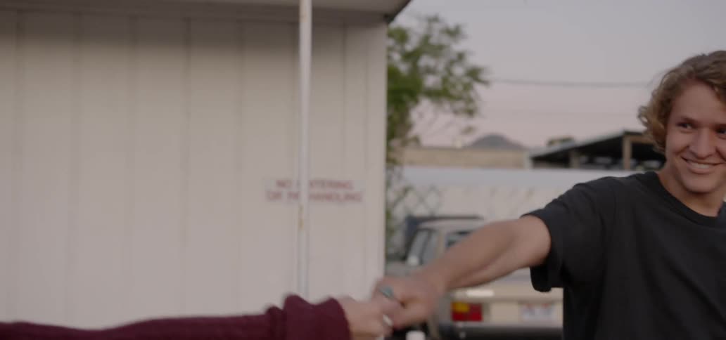 A man and woman dance outside