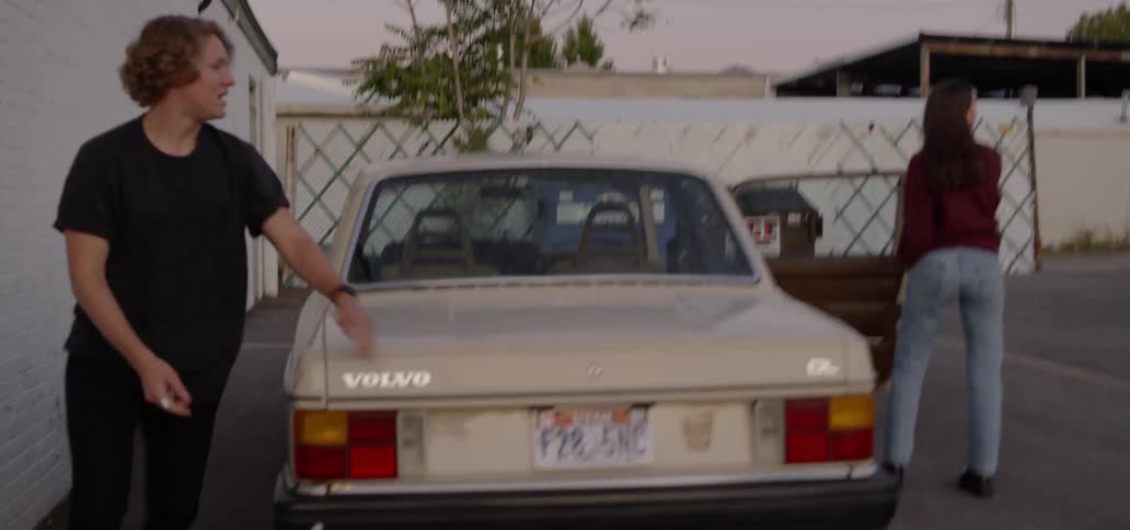 A man and woman getting out of a car then running and holding hands