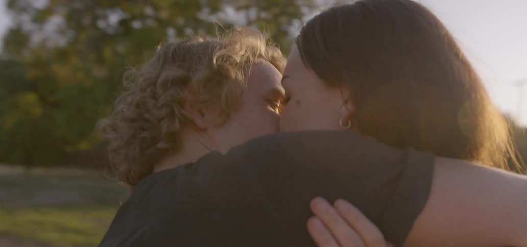 A couple kisses each other