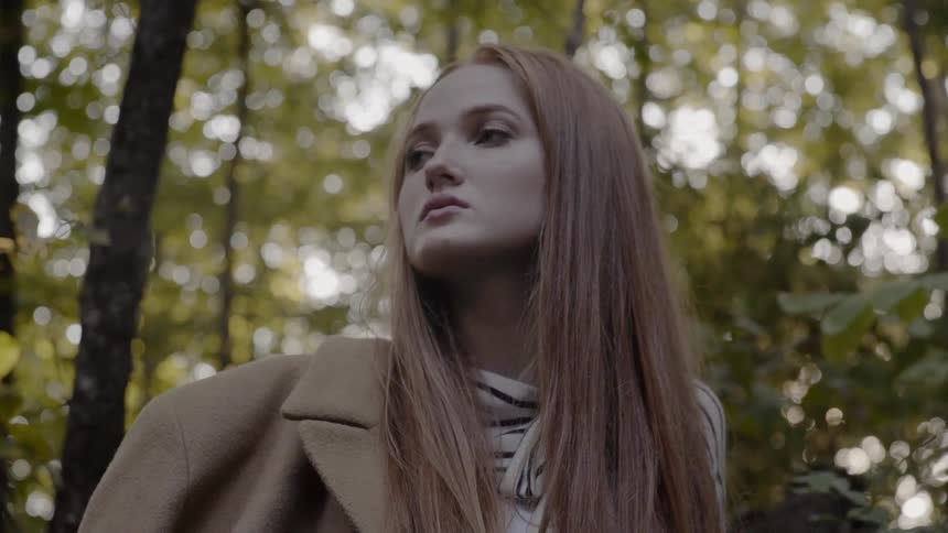 An arrogant young white woman looks into the distance