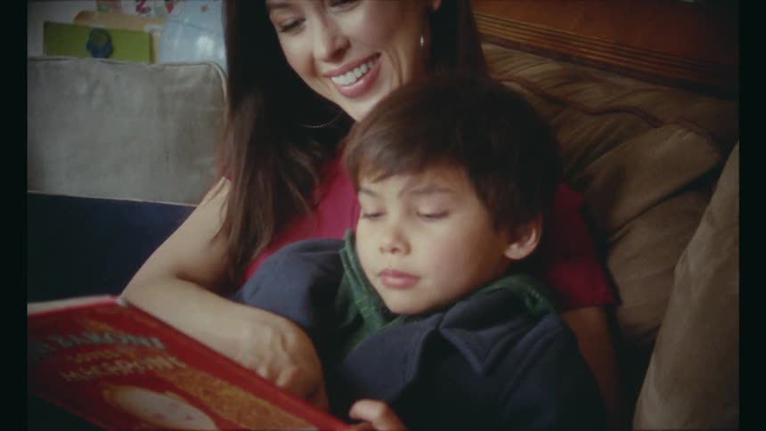 Mother reading a book to her son