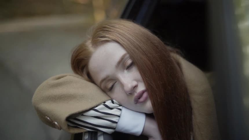 A woman leaning out of a car window