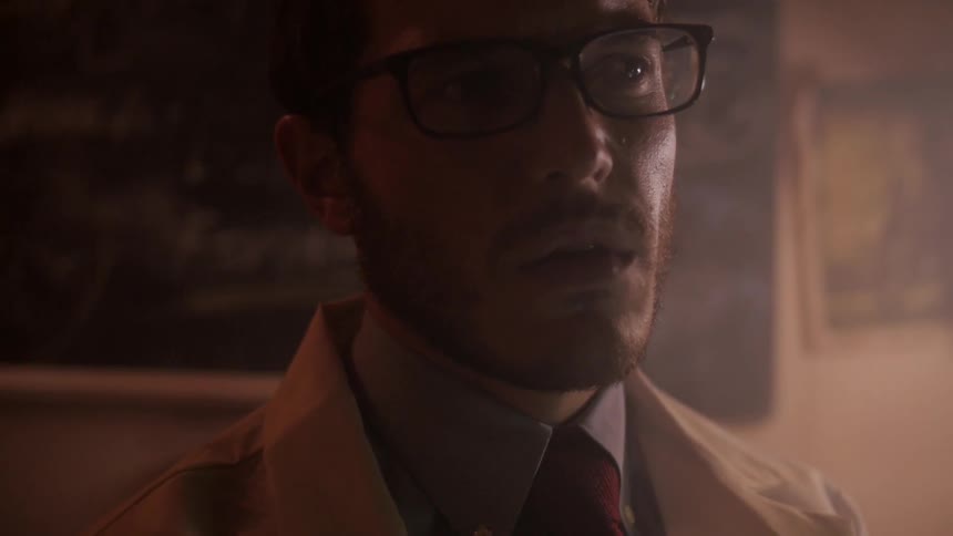 A young man looks bewildered in an office room