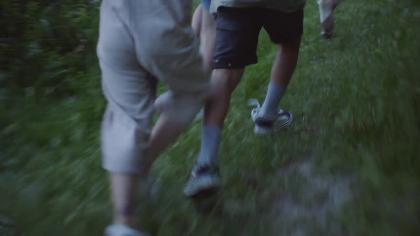 Children run along tail and one falls