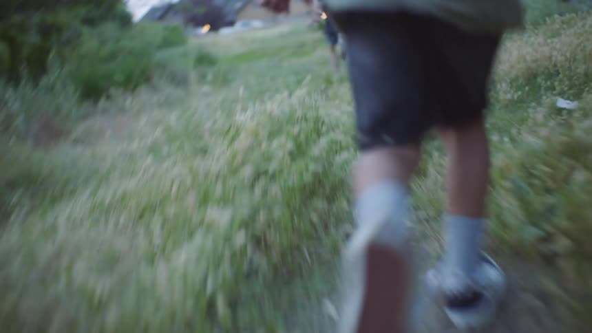 Children running and playing on a field in the country