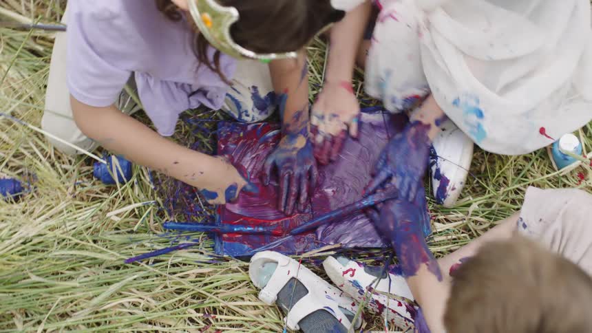 Children make messy art painting