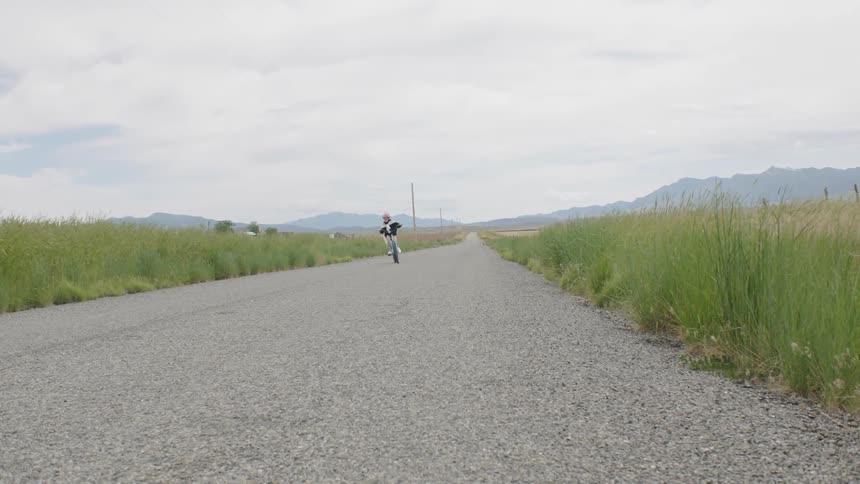 Child riding their bicycle down a paved path