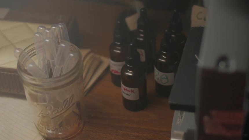 Bottles of medication and medical instruments shake violently on a desktop