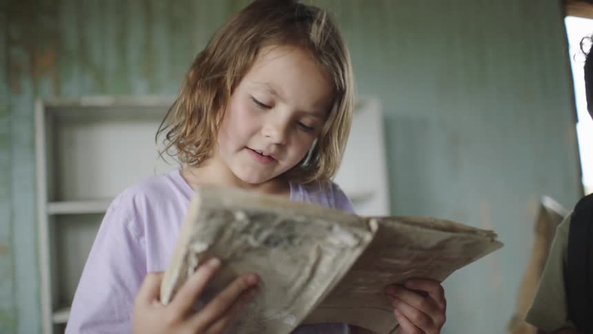 Children indoors reading a book