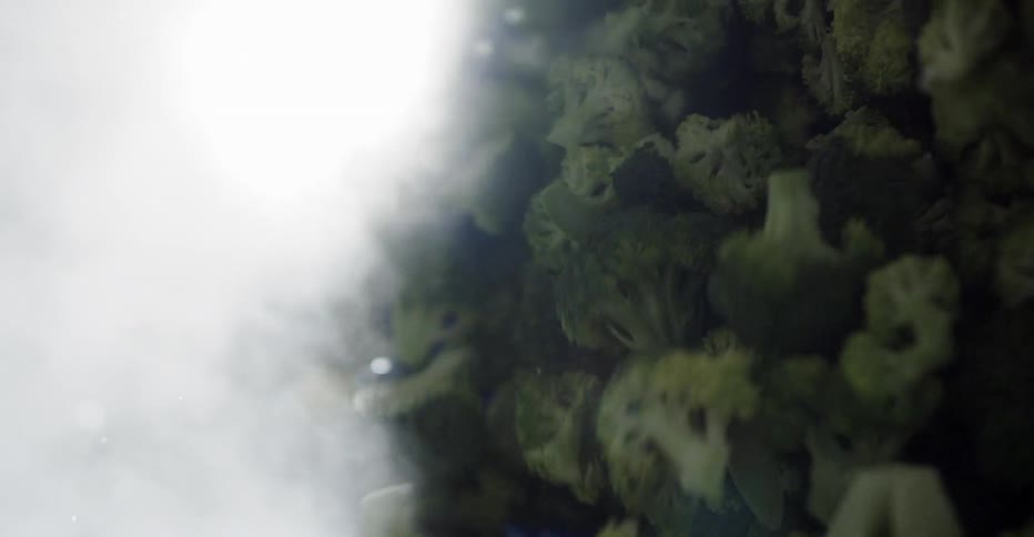 Broccoli being poured out of a container