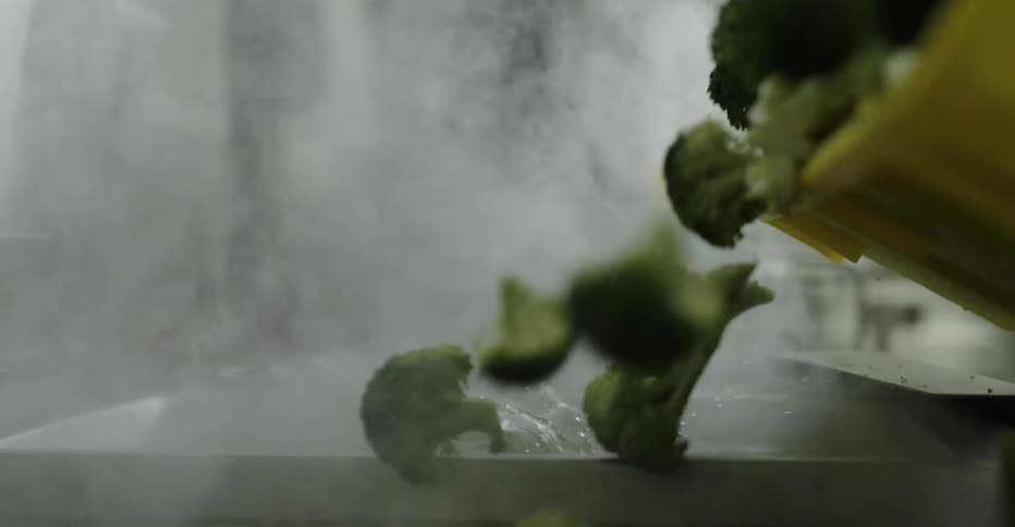 Broccoli being poured in to steaming water