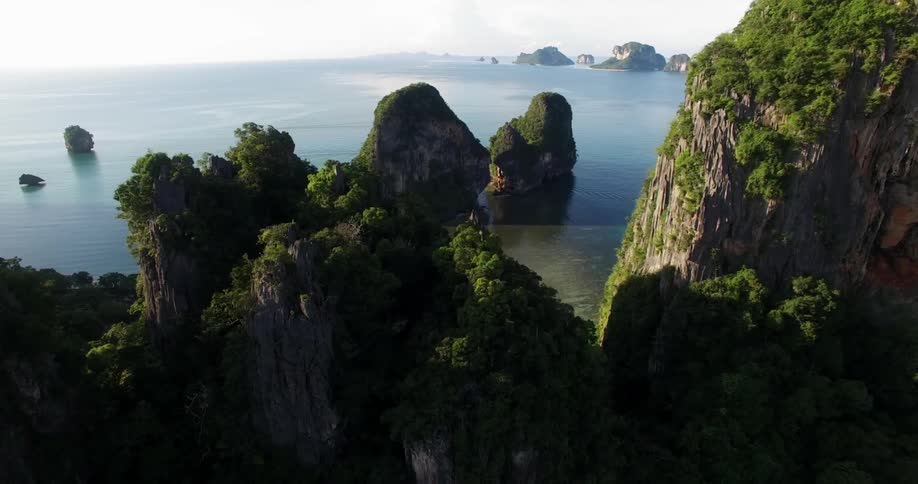 Large rock formations stand next to the ocean