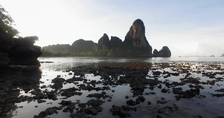 A shoreline is shown with rocks in the distance