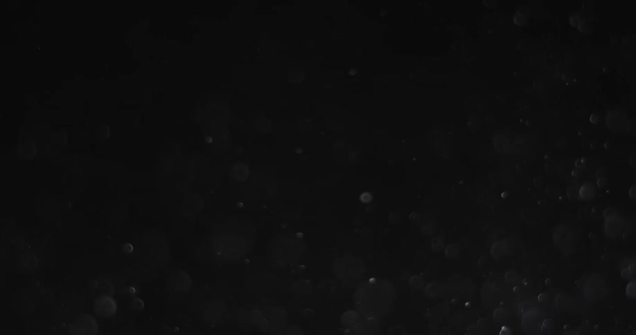 Dark room with small pieces of debris floating around