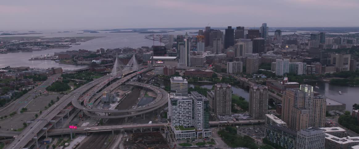 Traffic moves through a city on a gloomy and cloudy day