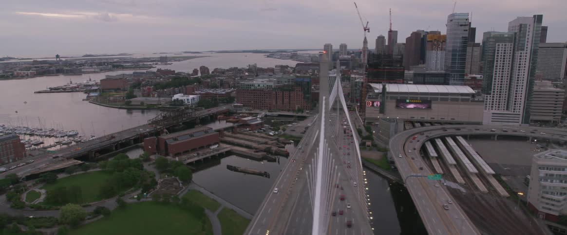 Cars travel over the bridge towards the city