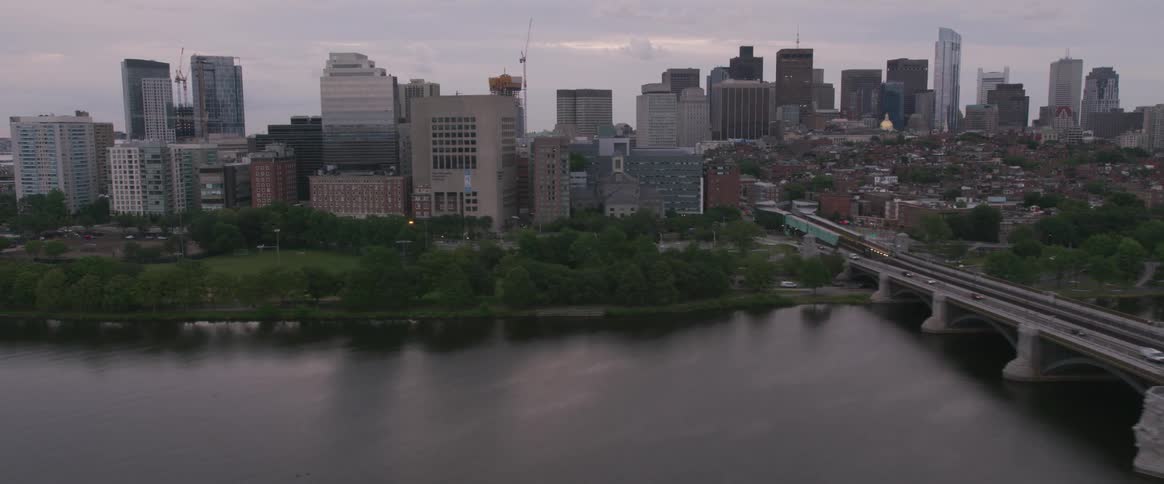 A bridge over water with the city in the background