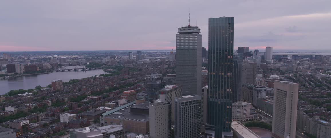 The camera flies over a large city