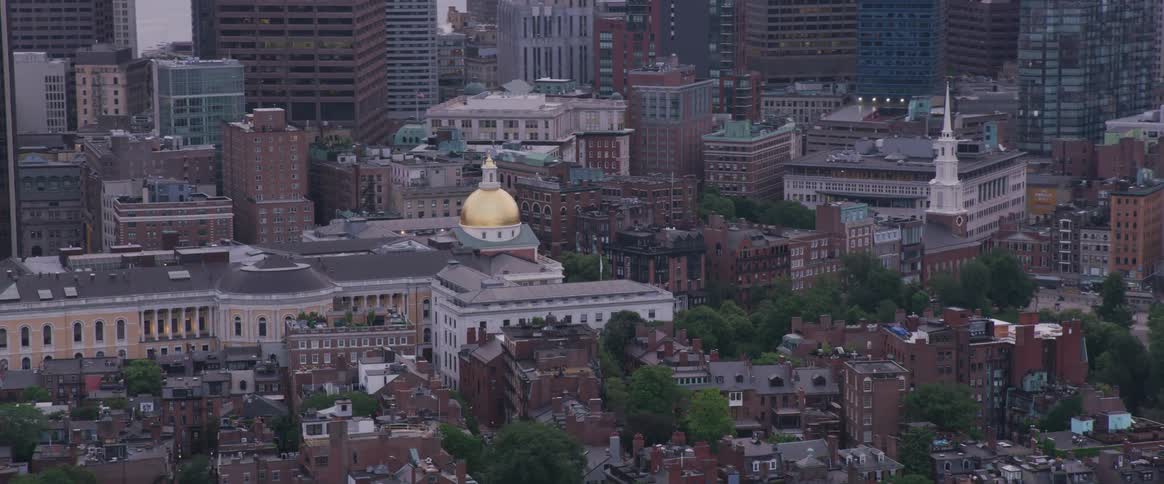 The apartment buildings surround the taller buildings in the city