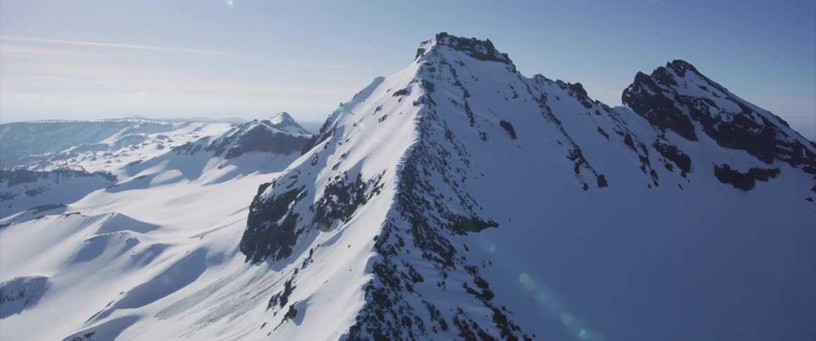 An aerial view of snowy mountains in the wilderness
