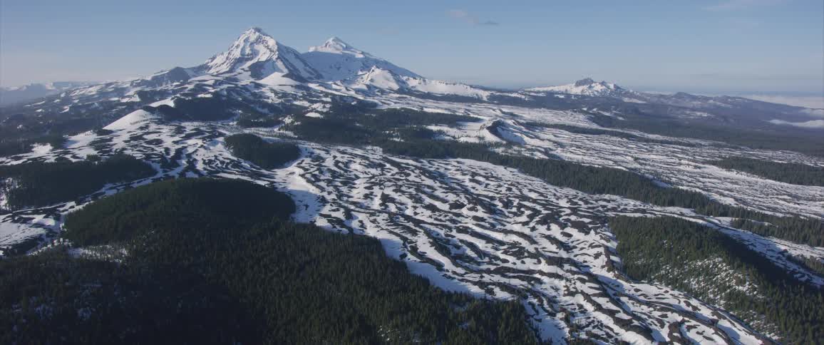 Aerial view of a snowy mountain landscape with trees