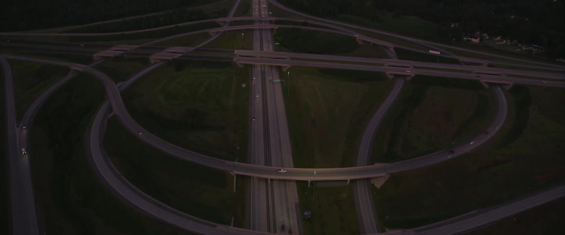 An aerial view of cars driving on a highway at night