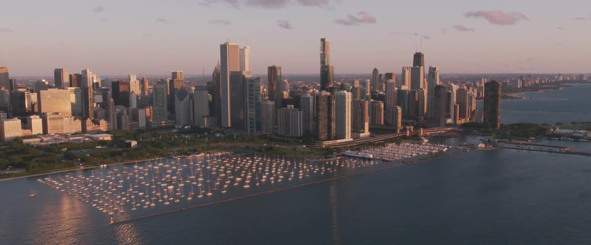 The sun is setting over the city by the water