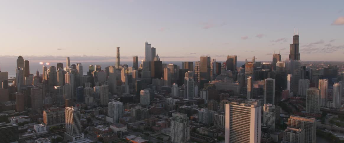 Skyline of the big city with tall buildings at sunset