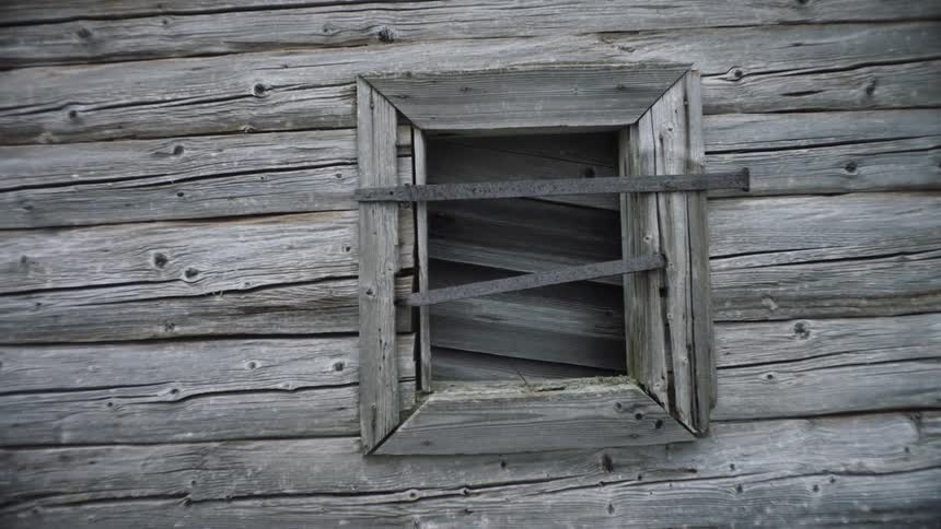 Boarded up window on rustic weathered wood building