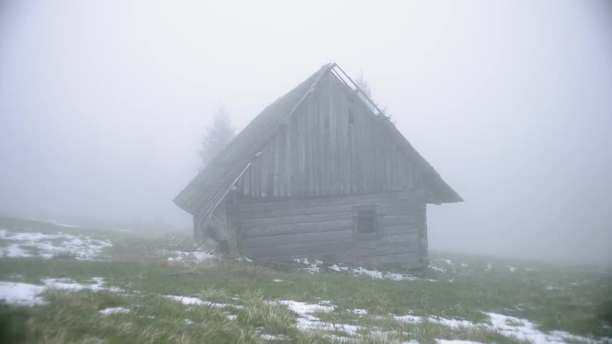 A house on the side of a grassy hill
