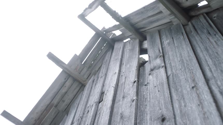 Boarded up window on wall of rustic abandoned cabin