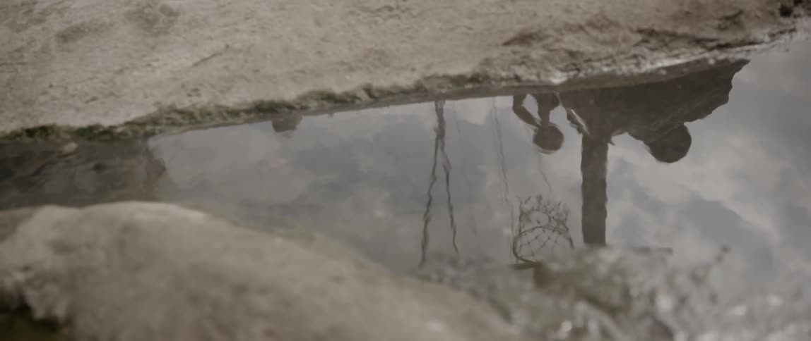 A reflection of people playing basketball