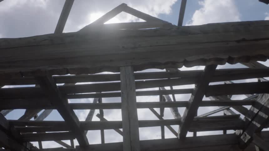 Camera walks through the old wooden building without walls and a roof