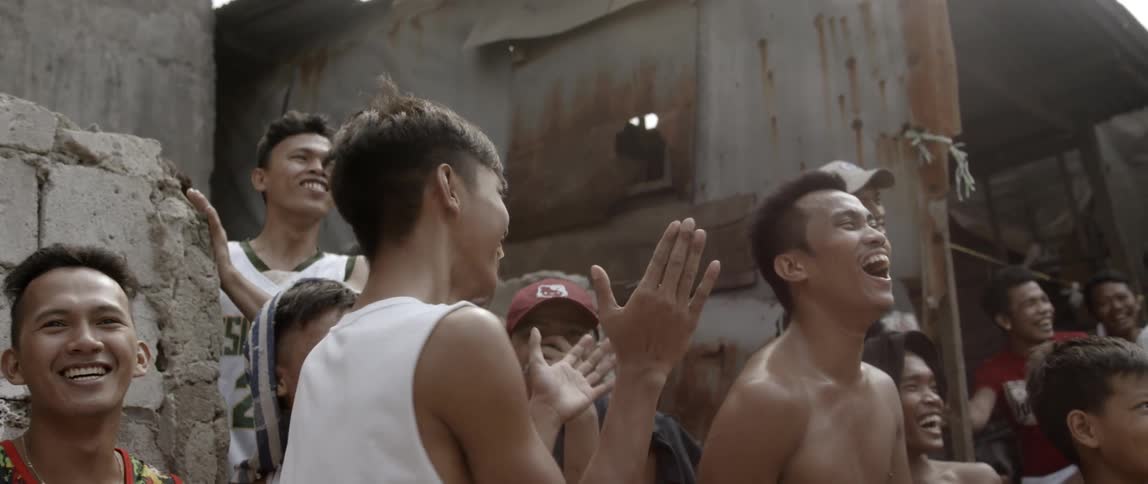 A group of people pointing and laughing
